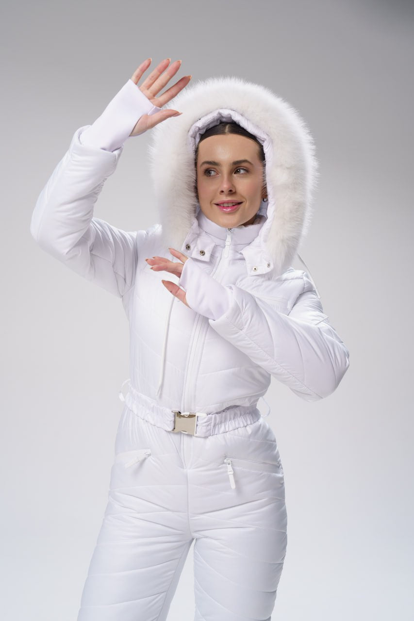 Person wearing a white winter outfit with a fur-lined hood on a gray background