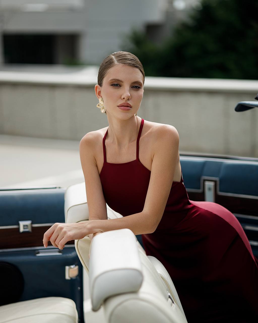 Woman in a red dress sitting on a boat with a blurred background
