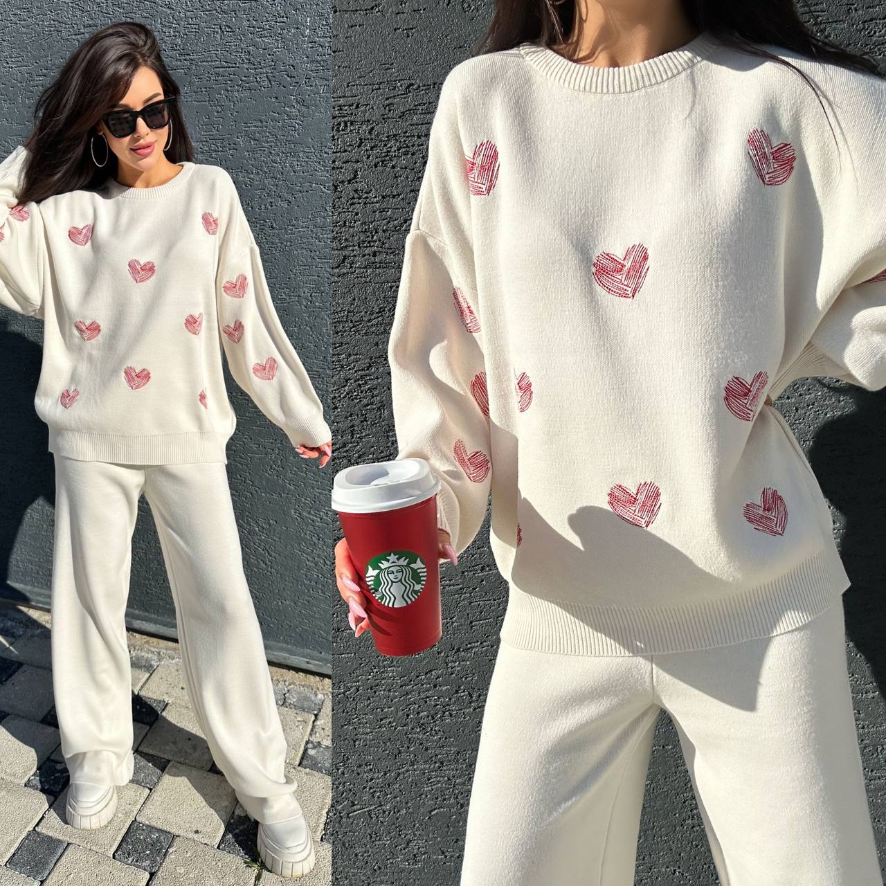 Woman wearing a white sweater with red heart patterns and white pants, holding a red Starbucks cup.