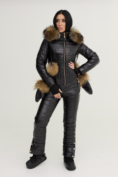 Person wearing a black snowsuit with fur trim on a white background