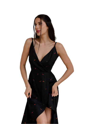 Woman wearing a black dress with red patterns on a white background