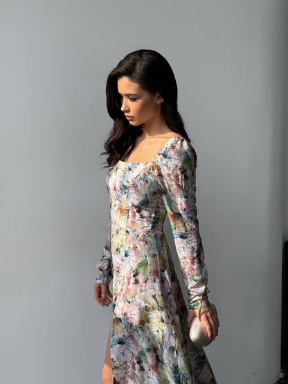 Woman wearing a floral dress against a gray background