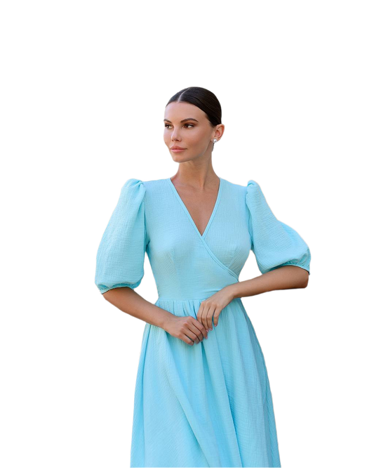 Woman wearing a light blue dress with puff sleeves on a white background