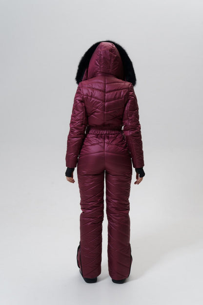Person wearing a maroon puffer suit with a hood on a white background
