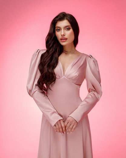 Woman wearing a pink dress against a pink background