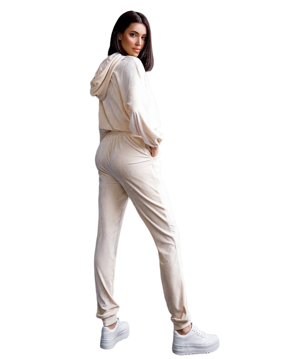 Woman wearing a beige tracksuit on a white background