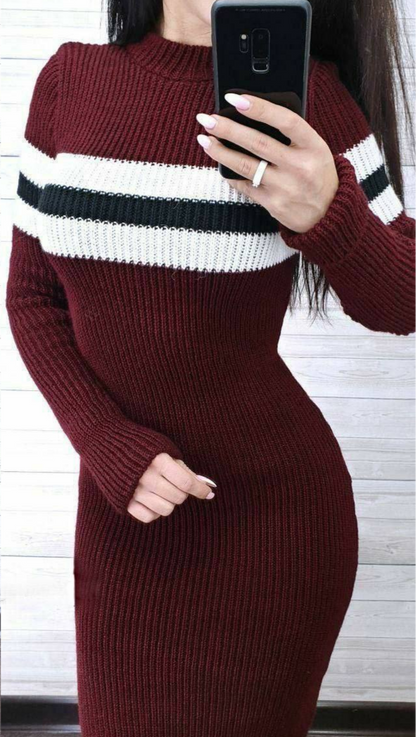 Person wearing a burgundy sweater with white and black stripes, taking a selfie.