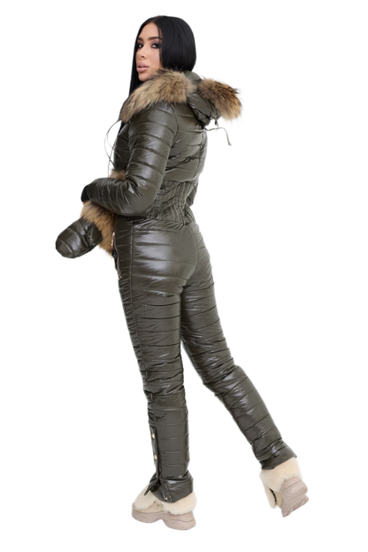 Person wearing a green puffer jumpsuit with fur trim on a white background