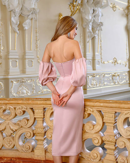 Woman in a pink dress standing in an ornate interior setting