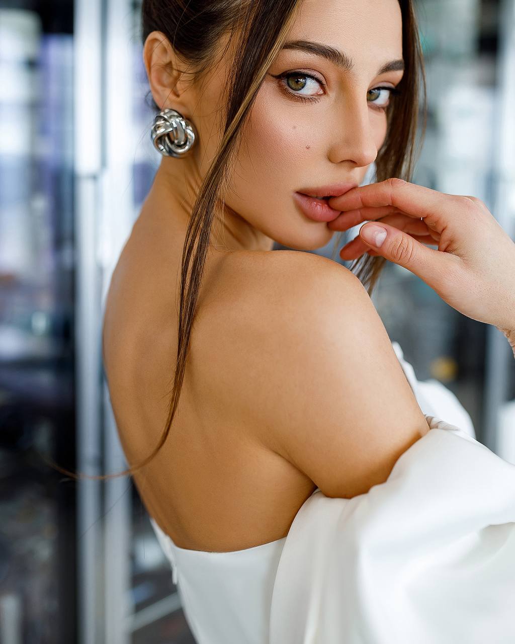 Woman with a stylish earring and a blurred background
