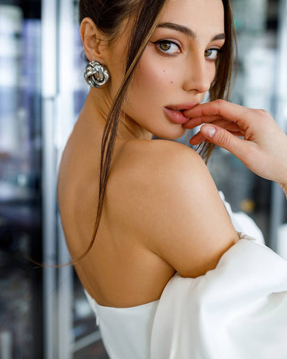Woman with a stylish earring and a blurred background