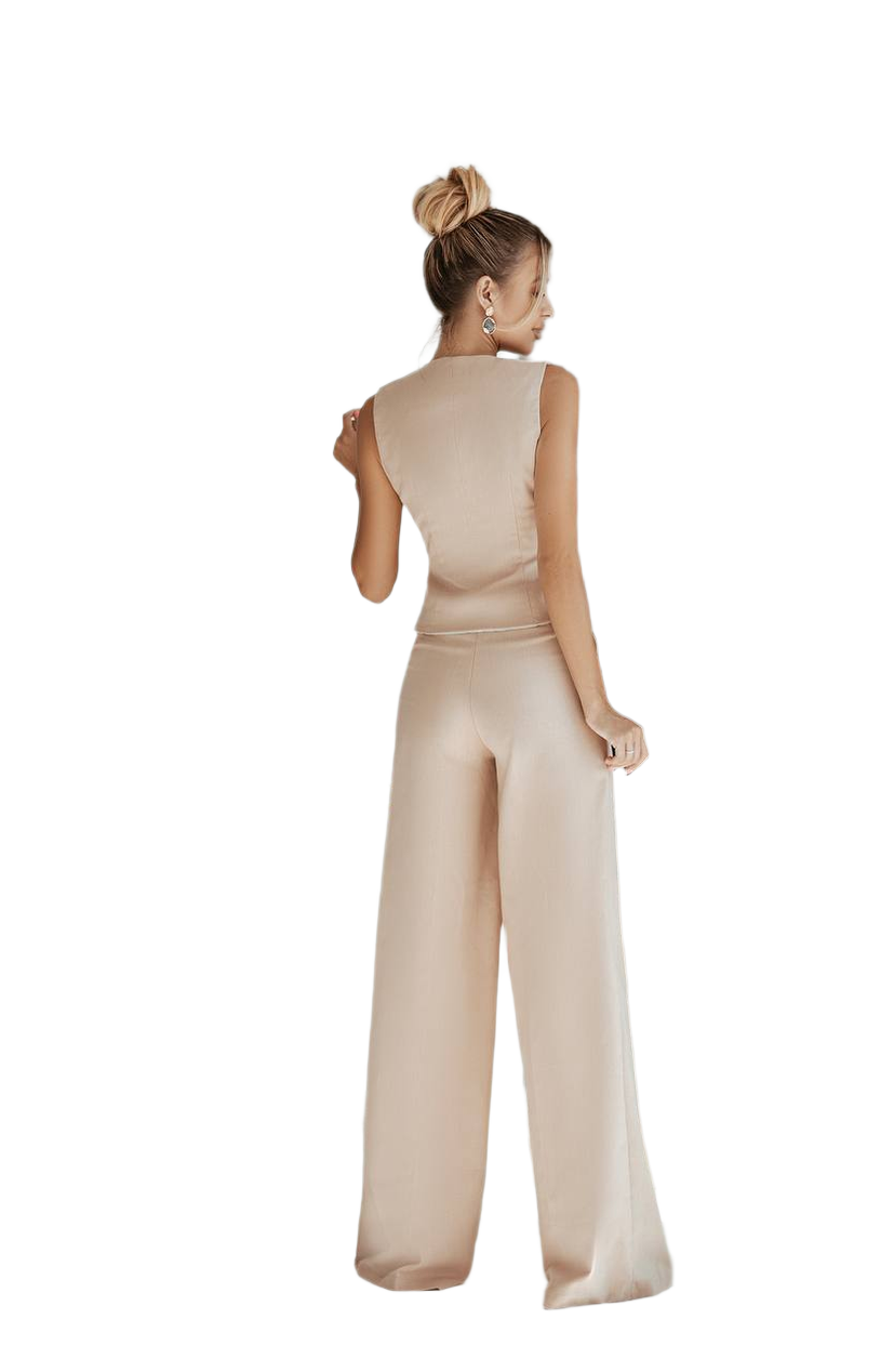 Woman wearing a beige jumpsuit on a white background