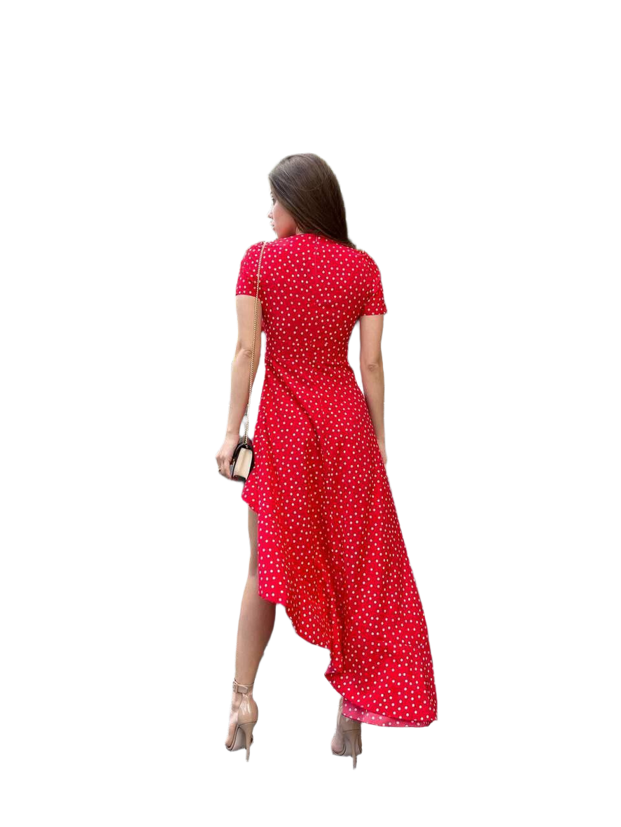 Woman wearing a red polka dot dress on a white background