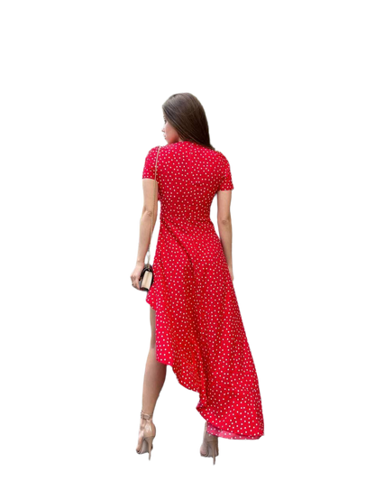 Woman wearing a red polka dot dress on a white background