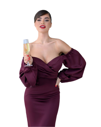 Woman in a burgundy evening gown holding a glass of champagne on a white background