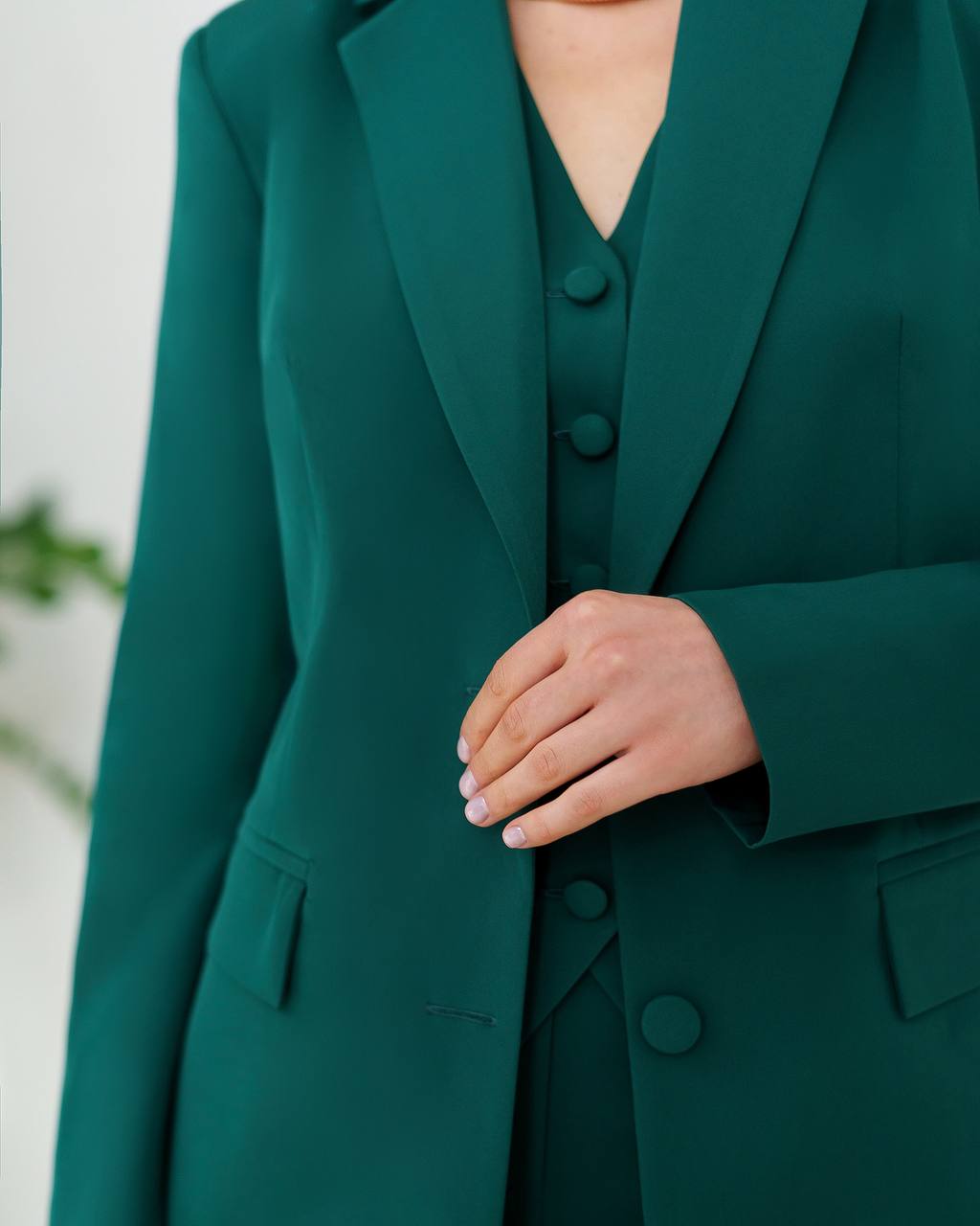Green blazer with buttons on a white background