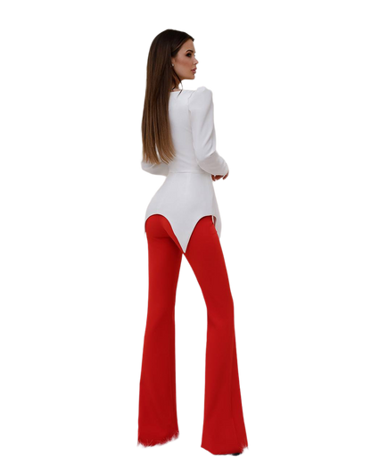 Woman wearing a white top and red flared pants on a white background