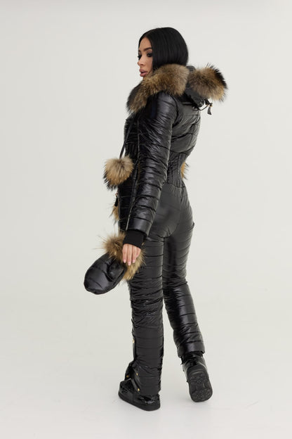 Person wearing a black winter suit with fur accents on a white background