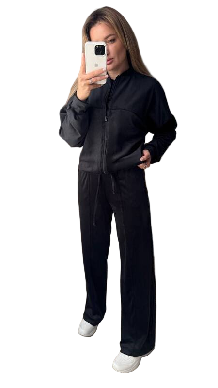 Person wearing a black jumpsuit on a white background