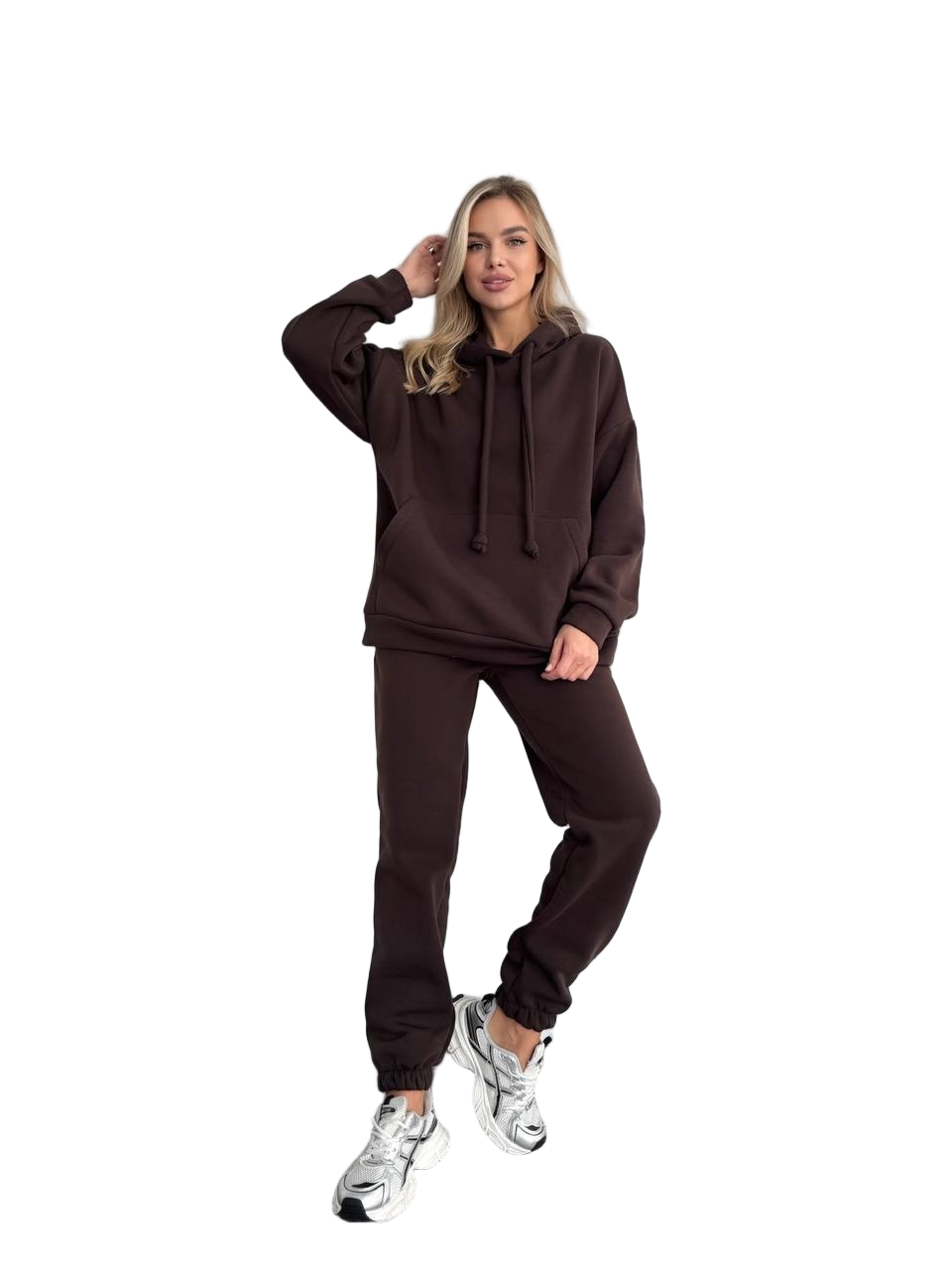 Woman wearing a brown tracksuit on a white background