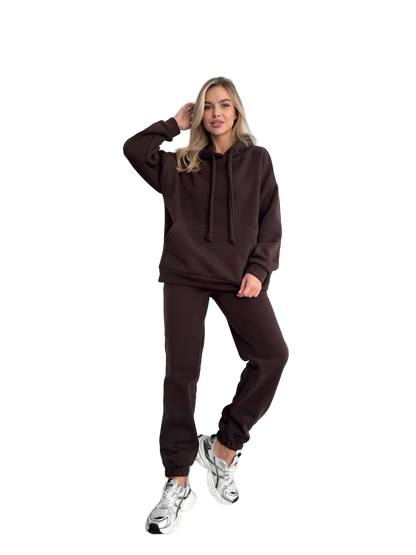Woman wearing a brown tracksuit on a white background