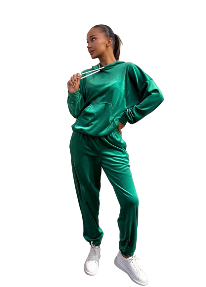 Woman wearing a green tracksuit on a white background