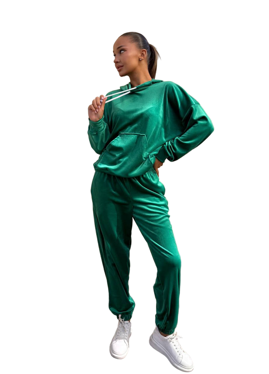 Woman wearing a green tracksuit on a white background