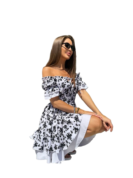 Woman wearing a black and white floral dress on a white background