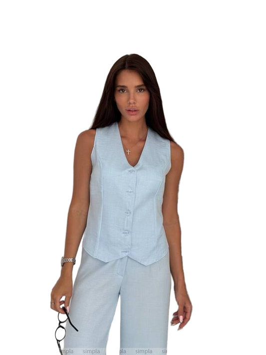 Woman wearing a light blue sleeveless top and pants on a white background