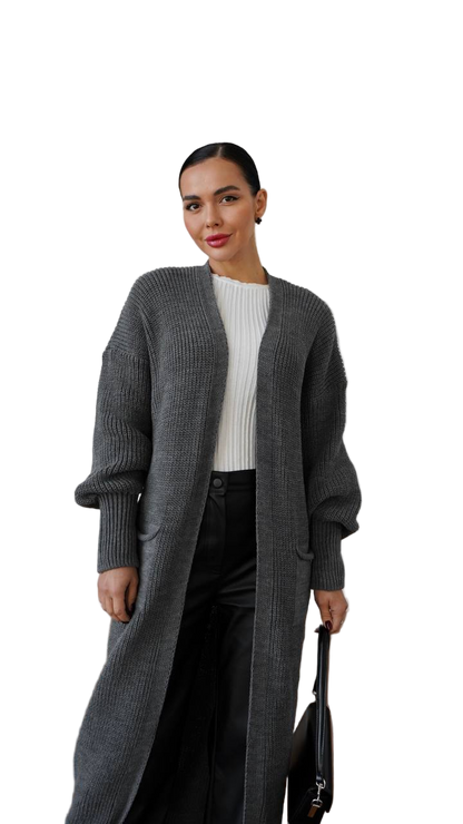 Woman wearing a long gray cardigan over a white top on a white background