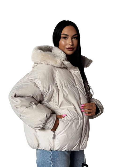 Woman wearing a white puffer jacket with fur hood on a white background