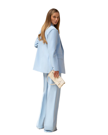Woman wearing a light blue suit with a white background