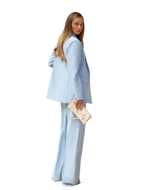 Woman wearing a light blue suit with a white background