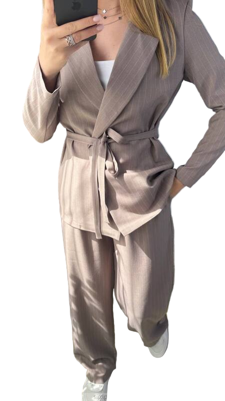 Person wearing a beige suit with a white background