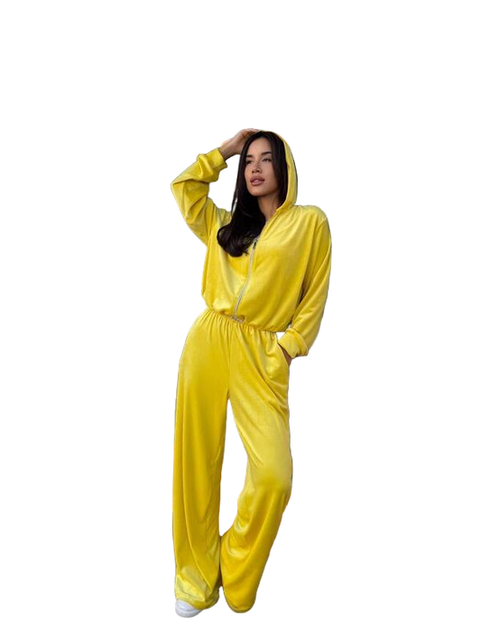 Woman wearing a yellow onesie against a white background