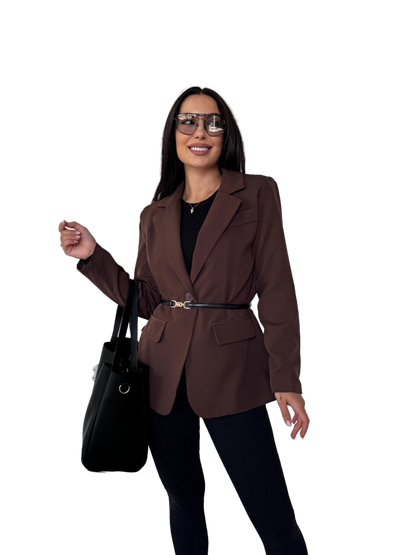 Woman wearing a brown blazer and black pants with a black handbag on a white background