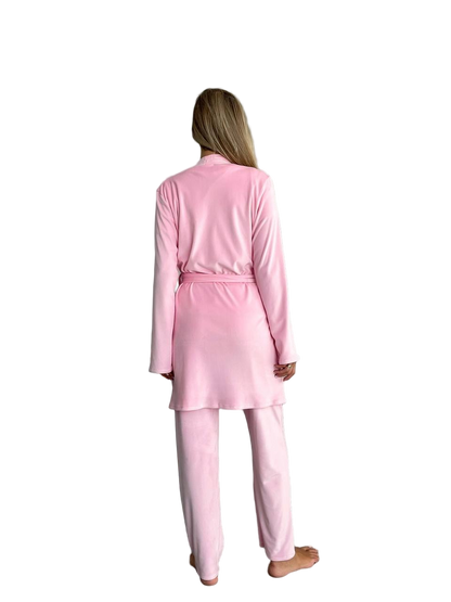 Person wearing a pink pajama set on a white background