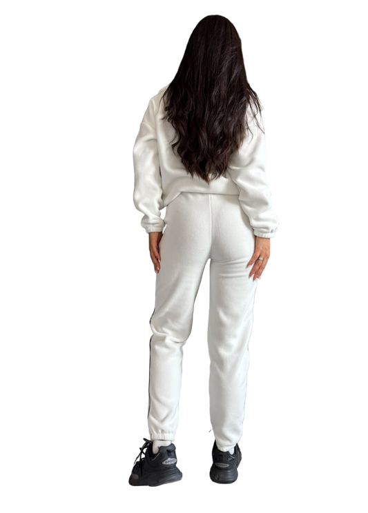 Person wearing a white tracksuit on a white background