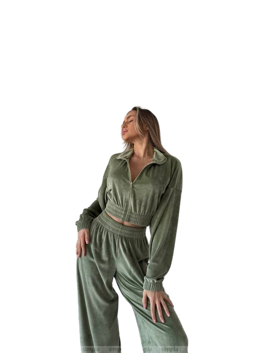 Woman wearing a green tracksuit on a white background