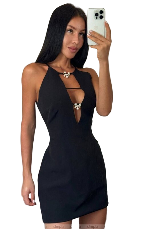 Woman taking a selfie wearing a black halter neck dress on a white background