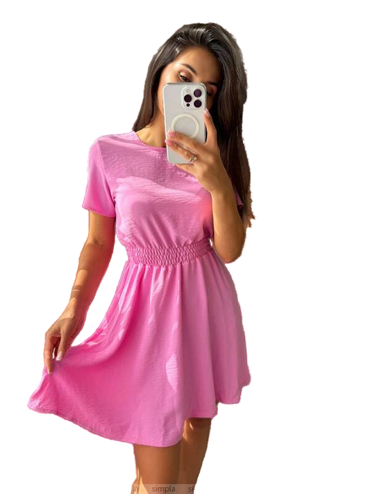 Woman wearing a pink dress with a beige handbag on a white background
