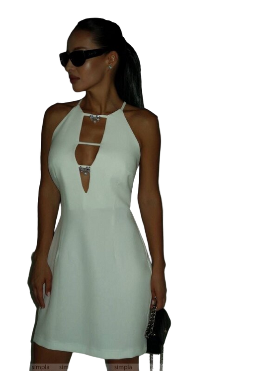 Woman wearing a light green dress with cut-out design on a white background