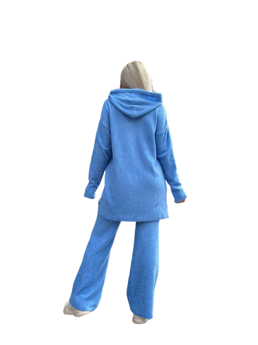 Person wearing a blue tracksuit on a white background