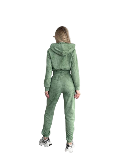 Person wearing a green tracksuit on a white background