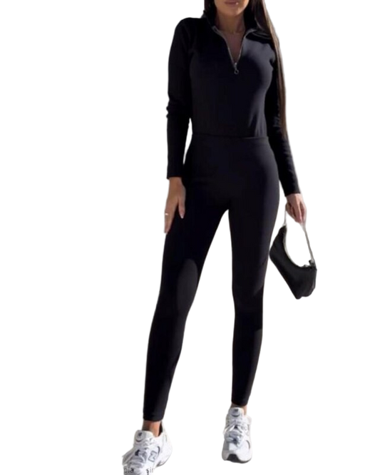 Woman wearing a black jumpsuit on a white background