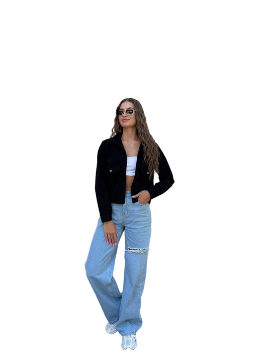 Woman wearing a black jacket, white top, and blue jeans on a white background