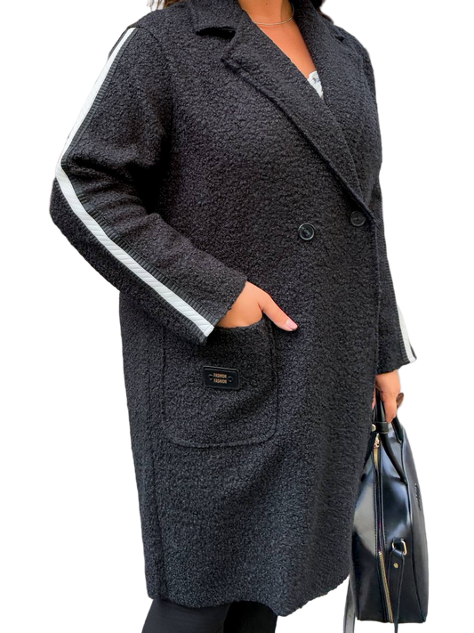 Person wearing a dark gray coat with white trim on a white background