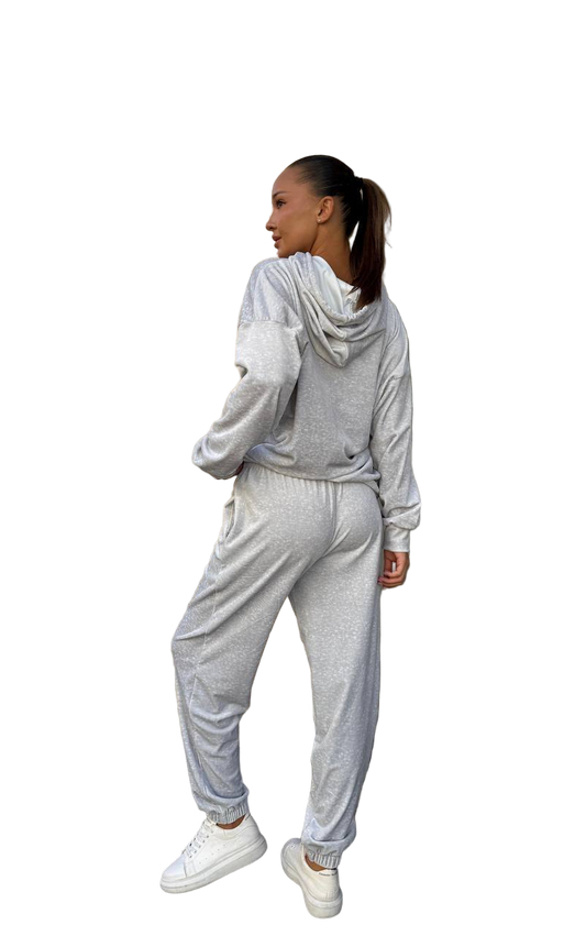Woman wearing a gray tracksuit on a white background
