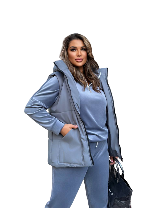 Woman wearing a blue tracksuit with a hood on a white background