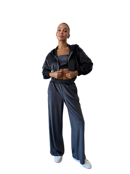 Person wearing a black tracksuit on a white background